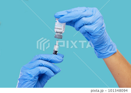 Mockup, closeup and hands with needle, vial and vaccination for diagnosis against a blue studio background. Zoom, hands and gloves, with medicine, cure and vaccination for medical diagnosis or result Mockup, closeup and hands with needle, vial and vaccination for diagnosis against a blue studio background. Zoom, hands and gloves, with medicine, cure and vaccination for medical diagnosis or result 101348094