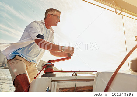 Retirement, luxury yacht and investment for mature man and sailing winch in mast control, wind management or speed. Person, tourism boat and rope handle in wealth holiday and water location vacation 101348398