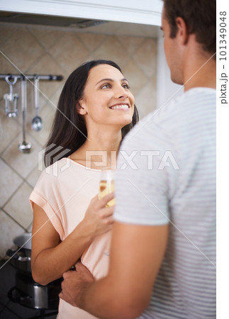 Toasting their future. A young woman holding a glass of wine and looking up at her boyfriend. Toasting their future. A young woman holding a glass of wine and looking up at her boyfriend. 101349048