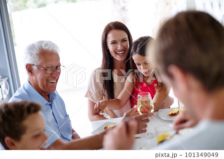 Sharing a meal with loved ones. a multi-generational family having a meal together. Sharing a meal with loved ones. a multi-generational family having a meal together. 101349049