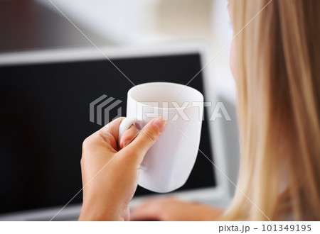 Woman with coffee cup and laptop. Closeup of business woman holding coffee cup while using laptop. Woman with coffee cup and laptop. Closeup of business woman holding coffee cup while using laptop. 101349195
