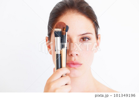 Woman, face and makeup brush in portrait, beauty and cosmetics isolated on white background. Mockup space, female in studio with cosmetic tools in hand and skincare, dermatology glow and wellness 101349196