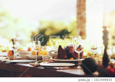 Food, table and traditional celebration on a patio with no people for thanksgiving, party and a fun gathering setup for family at home. Turkey, chicken and dining table ready for family lunch outdoor 101349933