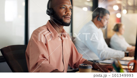Call center, customer support and face of a black man consultant doing online consultation in the office. Customer service, sales employee and telemarketing agent working on crm strategy in workplace 101349993