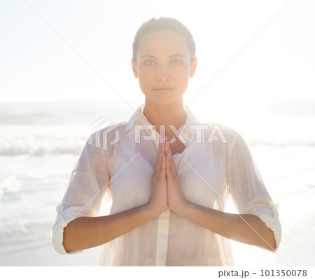 Nature helps me find peace. A beautiful young woman meditating outside. 101350078