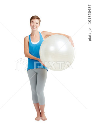 Portrait, workout and woman with fitness ball for wellness and health isolated against a studio white background. Exercise, training and fit happy female ready for healthy body and lifestyle 101350487