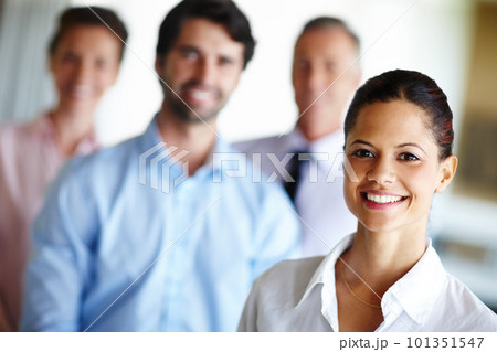 She will lead her team to greatness. A confident businesswoman standing infront of her colleagues. 101351547