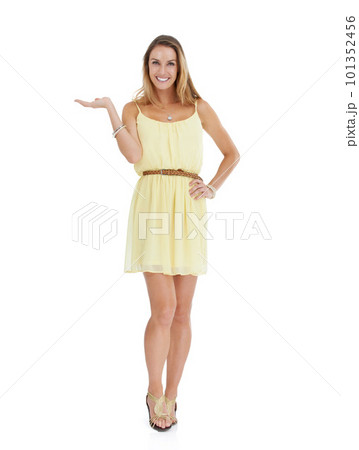 Woman, studio portrait and marketing hand with smile, yellow fashion dress and white background. Isolated young model, clothes and happy with copy space, beauty and product placement with open palm 101352456