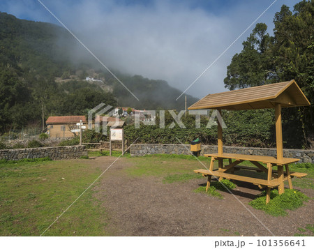 Picnic resting area with bench and table in mist laurisilva forest at the Garajonay National Park hiking trail El Cedro, La Gomera, Canary Islands, Spain. 101356641