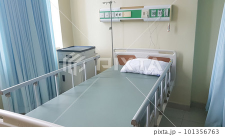Surakarta, Indonesia, Jan 2023, Interior of recovery room in intensive care unit at Muwardi Hospital. Empty bed with medical equipment in background Surakarta, Indonesia, Jan 2023, Interior of recovery room in intensive care unit at Muwardi Hospital. Empty bed with medical equipment in background 101356763