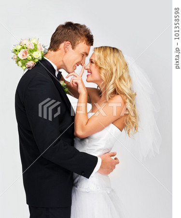 Happy couple in celebration at their wedding day, love in marriage and happiness of young man and woman at ceremony together. Bride and groom on white background, people smile with bouquet flowers Happy couple in celebration at their wedding day, love in marriage and happiness of young man and woman at ceremony together. Bride and groom on white background, people smile with bouquet flowers 101358598