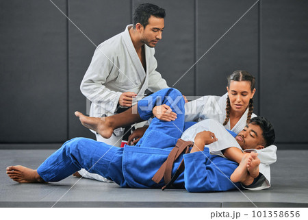 Mma, martial arts and exercise with a coach, teacher or instructor instructing students during practice, training or sparring in a gym or dojo. Fighting and self defense class for health and fitness 101358656
