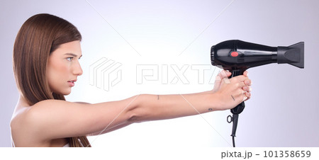 Hair care, dryer and woman with a styling product isolated on a white background in studio. Salon, beauty and a model with a cosmetic tool from a hairdresser for a hairstyle as a weapon on a banner 101358659
