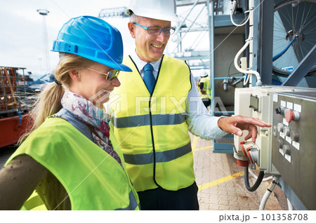 Supply chain, shipping and logistics with a manager and engineer working on a harbor in the export and import industry. Manufacturing, safety and management with industry workers operating machinery Supply chain, shipping and logistics with a manager and engineer working on a harbor in the export and import industry. Manufacturing, safety and management with industry workers operating machinery 101358708