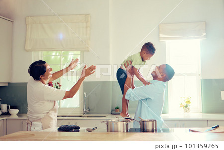 Family, father and son in the kitchen with happy, playful and joy time at home smiling in happiness. Parents in care, love and fun with child together in a house playing with smile and funny moments. 101359265