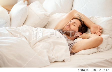 Relax, home and bed room for sleeping man lying on morning in house bedroom, hotel or luxury airbnb hospitality. Fatigue, burnout or tired person resting, dreaming or calm in healthy comfort blanket 101359612