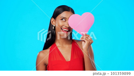 Thinking, happy or woman with heart paper sign for Valentines Day, studio care and emoji love icon, symbol or poster. Portrait, female beauty or person contemplating secret admirer on blue background 101359899