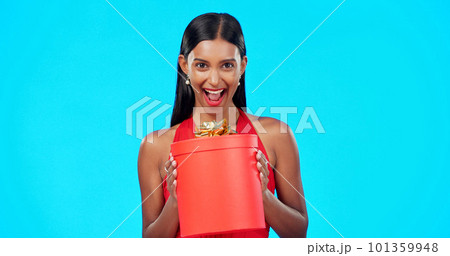 Gift box, retail and happy studio woman with sales product, discount birthday deal or Valentines Day present. Commerce market portrait, store container and luxury person isolated on blue background Gift box, retail and happy studio woman with sales product, discount birthday deal or Valentines Day present. Commerce market portrait, store container and luxury person isolated on blue background 101359948