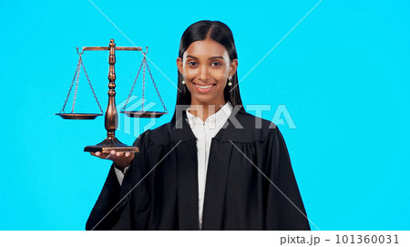 Portrait, balance scale or happy woman lawyer in studio for justice system, career services or marketing. Fair legal worker, mockup space or trusted Indian girl attorney with smile on blue background 101360031