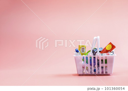Full shopping basket, food and groceries in shopping basket on pink background, copy space Full shopping basket, food and groceries in shopping basket on pink background, copy space 101360054