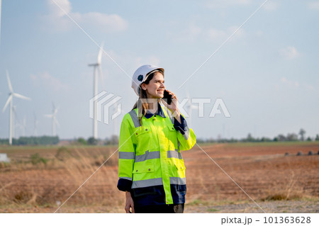 Engineer or technician woman with safety protection equipment stand with using mobile phone Engineer or technician woman with safety protection equipment stand with using mobile phone 101363628