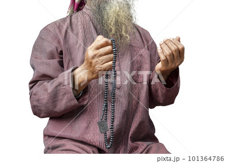 Muslim man with a beard wearing keffiyeh with agal praying with prayer beads on his hands Muslim man with a beard wearing keffiyeh with agal praying with prayer beads on his hands 101364786