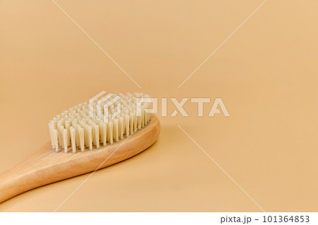 wooden massage brush with natural bristles on beige background wooden massage brush with natural bristles on beige background 101364853