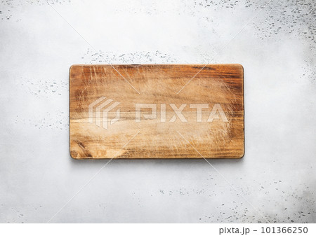 Empty scratched wooden cutting chopping kitchen board on light background. 101366250