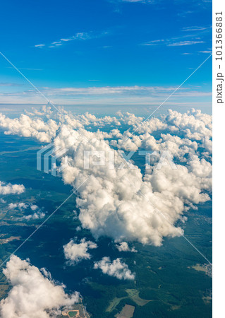 Aerial view from airplane window above green ground. View from the airplane window with beautiful clouds at sunrise Aerial view from airplane window above green ground. View from the airplane window with beautiful clouds at sunrise 101366881