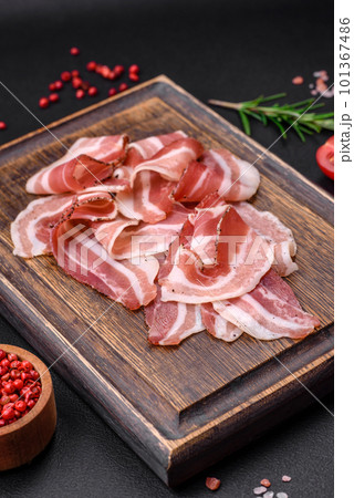 Delicious fresh pancetta with salt and spices cut into thin slices Delicious fresh pancetta with salt and spices cut into thin slices 101367486