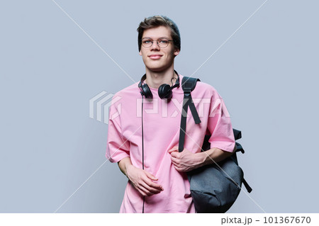 Trendy young male hipster in pink t-shirt on gray studio background 101367670