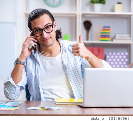 Young male designer working in the office 101369662