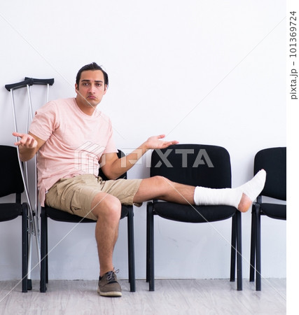 Young injured man waiting for his turn in hospital hall 101369724