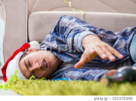Man having hangover after christmas party 101370300