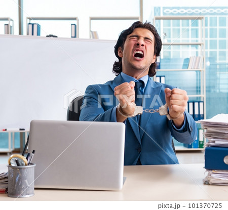 Chained male employee unhappy with excessive work Chained male employee unhappy with excessive work 101370725
