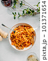 Pasta bavette with fried shrimps, bechamel sauce. Woman hands in frame, girl eats pasta, holds fork in hands, top view, italian cuisine. 101371654