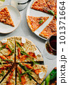 Traditional Italian pizza, vegetables, ingredients on a light background.Top view. a piece of pizza in the hand.Festive table. company of friends 101371664