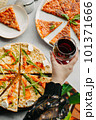 Traditional Italian pizza, vegetables, ingredients on a light background.Top view. a piece of pizza in the hand.Festive table. company of friends 101371666