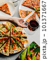 Traditional Italian pizza, vegetables, ingredients on a light background.Top view. a piece of pizza in the hand.Festive table. company of friends 101371667