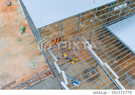 During construction of an industrial warehouse building, steel frames will be used for trusses 101372779