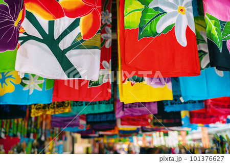 Sarong skirts shop at city market of Papeete, Tahiti, French Polynesia. Colorful clothing pareo wrap hanging for sale as handmade tourism souvenir. 101376627