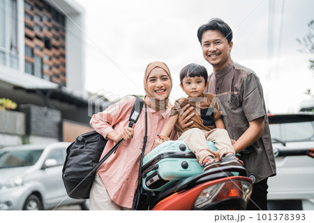 muslim family going with motorbike together during eid mubarak 101378393