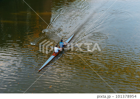 Aerial drone bird's eye view of sport canoe operated by 2 young men in turquoise clear waters. Kayaking on the river. Two young men sit in kayaks. The concept of water entertainment. 101378954