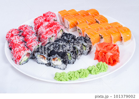 Japanese seafood Sushi roll isolated on white close up. Japanese food restaurant, sushi maki gunkan roll plate or platter set. Maki Sushi rolls with salmon and avocado. Sushi isolated at white 101379002