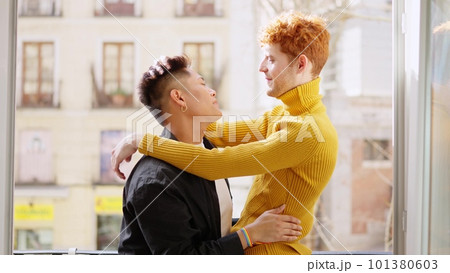 Romantic scene of a gay couple at the balcony at home Romantic scene of a gay couple at the balcony at home 101380603