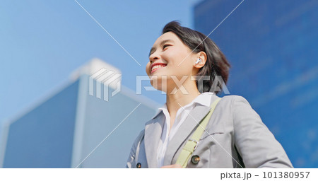 businessfemale use earbuds businessfemale use earbuds 101380957