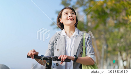 woman walking with electric scooter woman walking with electric scooter 101381619