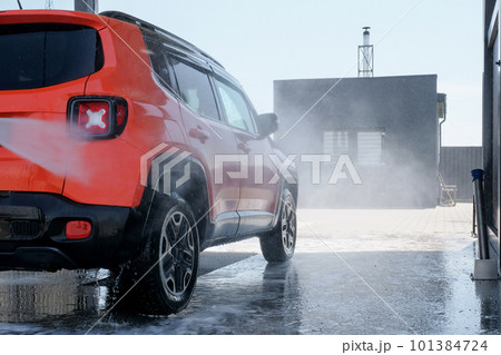 Manual car wash with high pressure water in the open air. Car at a car wash close-up 101384724