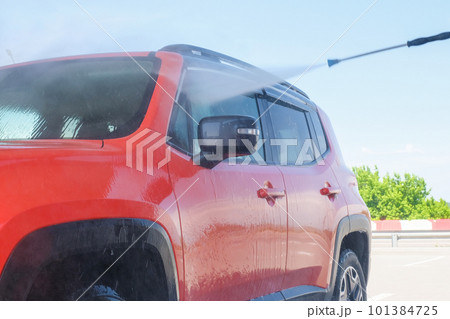 Car wash at a car wash under high water pressure Car wash at a car wash under high water pressure 101384725