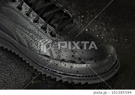Male shoe with water drops on a black background close up. Male shoe with water drops on a black background close up. 101385594